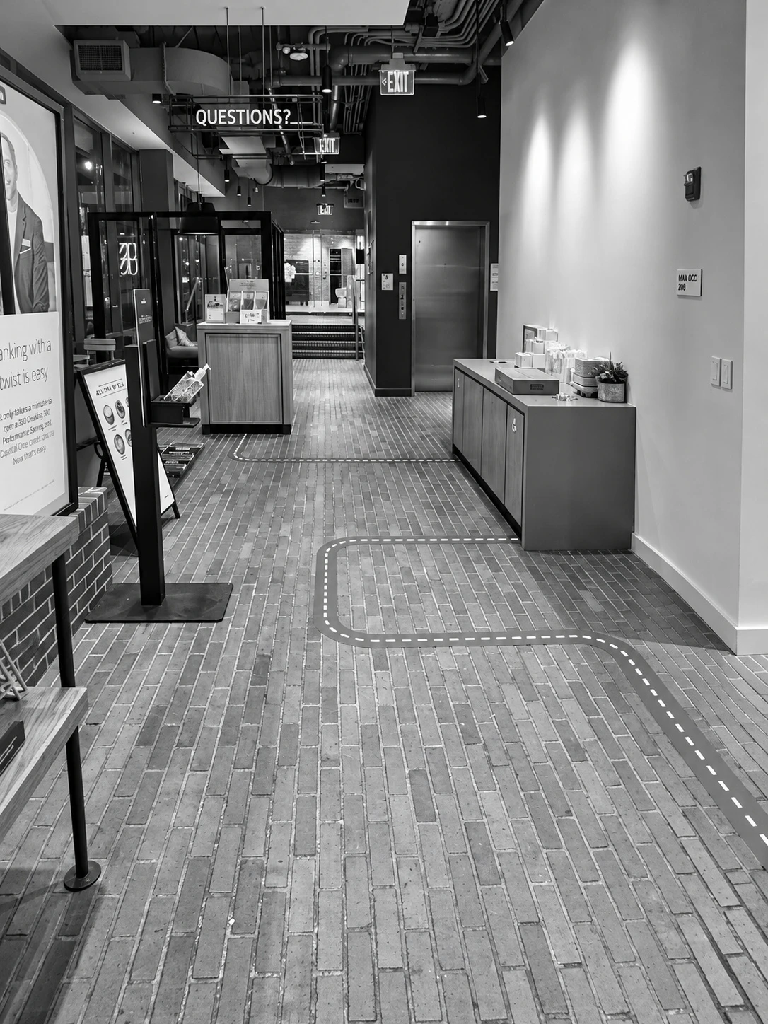 Road-style floor graphics through a commercial café interior